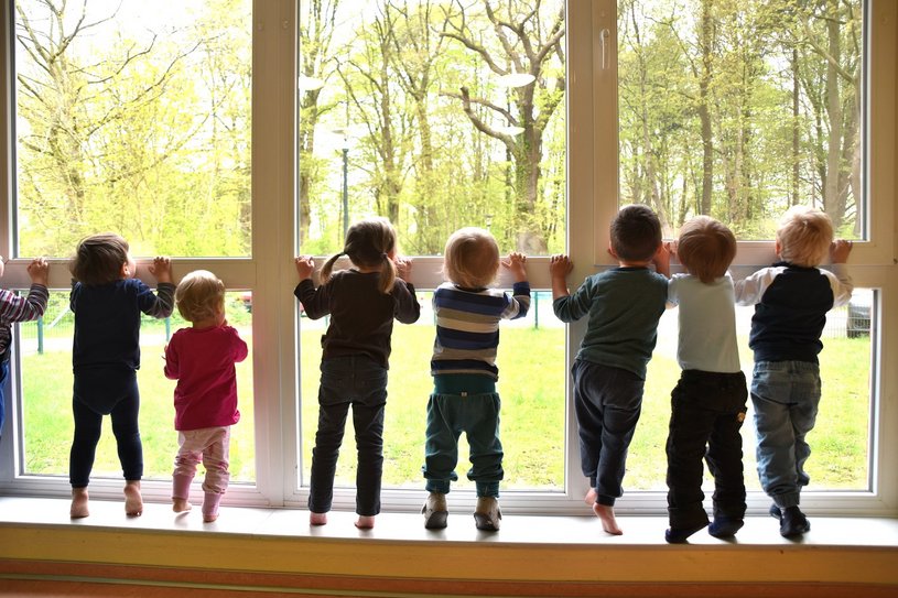 Kinder schauen aus dem Fenster